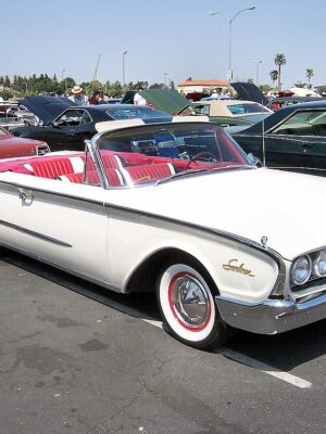 White 1960 Ford Galaxie Sunliner Convertible with white exterior, red leather interior. The convertible top is down.